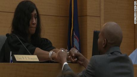 John Bunn holds hands with Judge ShawnDya Simpson at the hearing where he was exonerated after 27 years.