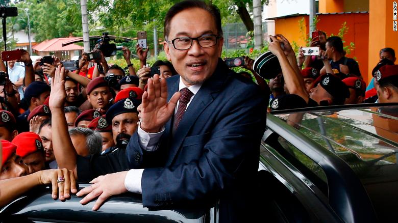 Malaysia&#39;s reformist icon Anwar Ibrahim, center, waves to his supporters and journalists after leaving a hospital in Kuala Lumpur,  Wednesday, May 16.