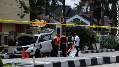 Indonesian policemen examine a car used by attackers outside the police headquarters in Pekanbaru, Riau, following attacks on May 16.