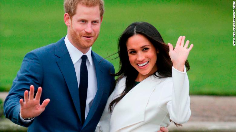 Harry and Meghan pose for photographers in the Sunken Garden at Kensington Palace in west London on November 27, 2017, following the announcement of their engagement.