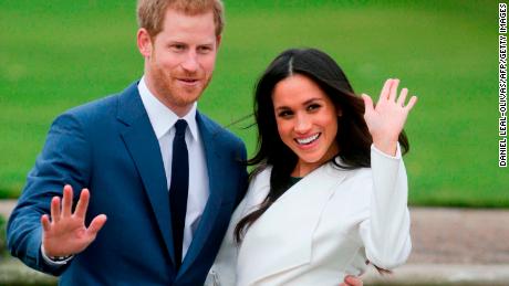 Harry and Meghan pose for photographers in the Sunken Garden at Kensington Palace in west London on November 27, 2017, following the announcement of their engagement.