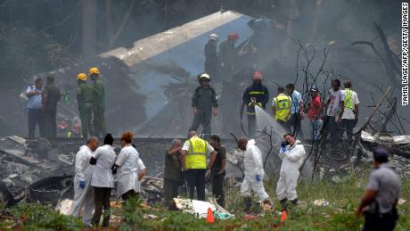 TOPSHOT - Emergency personnel works at the site of the accident after a Cubana de Aviacion aircraft crashed after taking off from Havana&#39;s Jose Marti airport on May 18, 2018. - A Cuban state airways passenger plane with 113 people on board crashed on shortly after taking off from Havana&#39;s airport, state media reported. The Boeing 737 operated by Cubana de Aviacion crashed &quot;near the international airport,&quot; state agency Prensa Latina reported. Airport sources said the jetliner was heading from the capital to the eastern city of Holguin. (Photo by Yamil LAGE / AFP)        (Photo credit should read YAMIL LAGE/AFP/Getty Images)