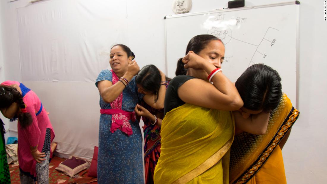 Trainers from the Delhi Police teach women how to fight an attacker if he approaches from behind.