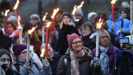 People hold torches during a rally in support of the #MeToo movement in Stockholm in January. 