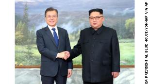 The North and South Korean leaders greet each other before Saturday's meeting.