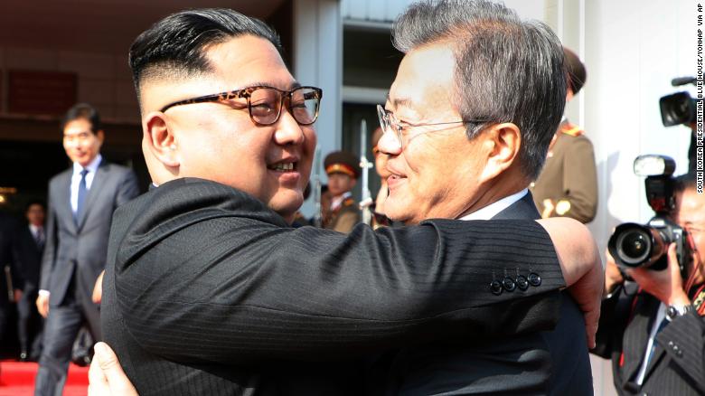 A photo provided by South Korea Presidential Blue House shows Kim Jong Un and Moon Jae-in hugging Saturday.