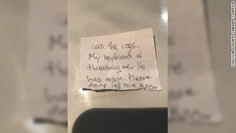 Woman slips note to veterinary staff pleading for rescue from boyfriend, police say