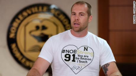 Jason Seaman, a seventh grade science teacher at Noblesville West Middle School in Noblesville, Ind., speaks to the media during a press conference Monday, May 28, 2018. Seaman tackled and disarmed a student with a gun at the school on Friday. He was shot but not seriously injured. (AP Photo/Michael Conroy)