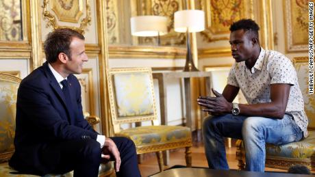 French President Emmanuel Macron (L) speaks with Mamoudou Gassama, 22, from Mali, at the presidential Élysée Palace in Paris, on May 28.