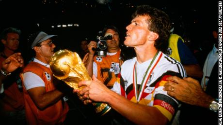 Germany captain Lothar Matthäus holds aloft the World Cup trohpy after defeating Argentina 1-0 in 1990.