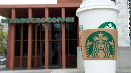 A Starbucks coffee cup is seen outside a Starbucks Coffee shop in Washington, DC, April 17, 2018, following the company&#39;s announcement that they will close more than 8,000 US stores on May 29 to conduct &quot;racial-bias education&quot; following the arrest of two black men in one of its cafes. / AFP PHOTO / SAUL LOEB        (Photo credit should read SAUL LOEB/AFP/Getty Images)