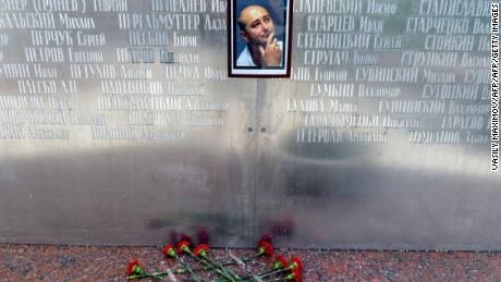 Flowers lie under a picture of Babchenko placed on the memorial wall of Moscow&#39;s journalists house before he was revealed to be alive.