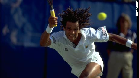 SEP 1989:  YANNICK NOAH OF FRANCE PERFORMS A RUNNING FOREHAND DURING A MATCH AT THE 1989 US OPEN PLAYED AT FLUSHING MEADOWS IN NEW YORK.