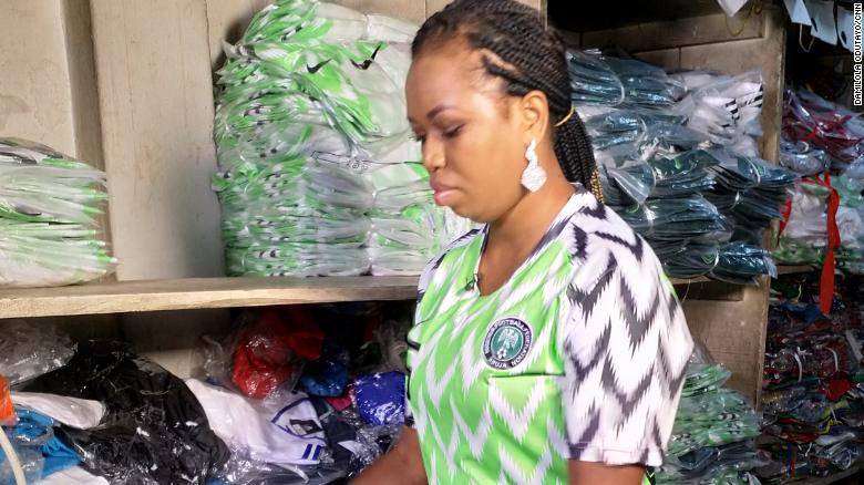 A counterfeit kit seller sorts her wares in her shop in Lagos on May 31 2018 ahead of the official release of the Nigeria World Cup kit. 