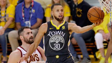 Golden State Warriors guard Stephen Curry (30) shoots against Cleveland Cavaliers forward Kevin Love (0) during the first half of Game 2 of basketball&#39;s NBA Finals in Oakland, Calif., Sunday, June 3, 2018. (AP Photo/Marcio Jose Sanchez)