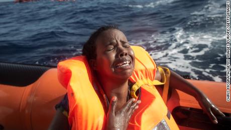 A refugee cries after losing her baby in the water off the Italian coast in May.