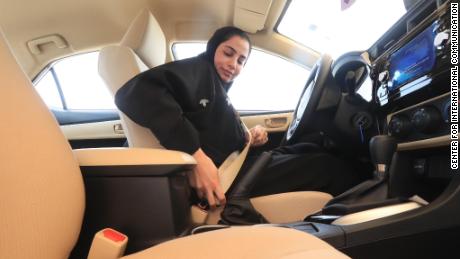 A Saudi woman buckles up in a test car before doing a driving test at the General Department of Traffic in the Saudi capital of Riyadh.