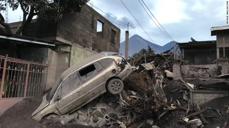 An abandoned car rests atop debris Wednesday in El Rodeo, Guatemala, after the volcano&#39;s eruption.