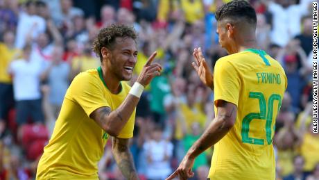 Brazil teammates Neymar and Roberto Firmino celebrate during a friendly against Croatia this month. If forecasts are right, the two attackers will be celebrating in Moscow at the World Cup final on July 15.