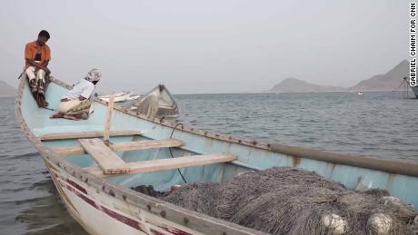 Fishermen at a village where human traffickers operate. 