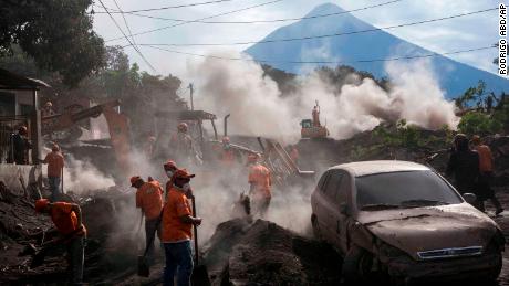 Rescue workers remove piles of ash spewed by the Volcan de Fuego, or &quot;Volcano of Fire,&quot; eruption, in El Rodeo, Guatemala, Wednesday, June 6, 2018. Wednesday morning rescuers were concerned about possible dangers posed not only by more volcanic flows but also rain. Authorities have said the window is closing on the chances of finding anyone else alive in the devastation. (AP Photo/Rodrigo Abd)
