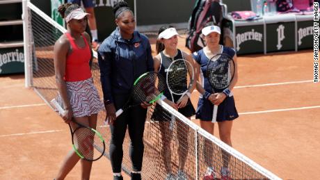 Venus and Serena Williams stand together at the 2018 French Open.