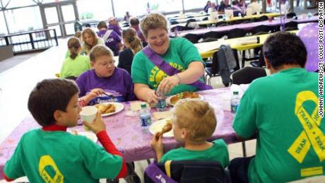 Evan Piña-White, in the purple shirt, sits next his mom, Mary, in this 2012 photo.
