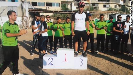 Alaa Al-Dali (C) qualified to be part of the Palestinian cycling team for Asia games. Then he lost his leg during a protest.