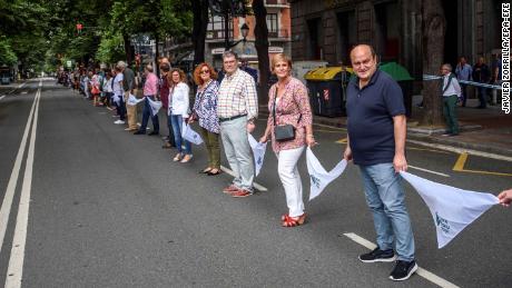 Basque Nationalist Party&#39;s senior officials Andoni Ortuzar (right to left) and Itxaso Atutxa and Bilbao Mayor Juan Mari Aburto take part in the human chain in Bilbao, northern Spain.