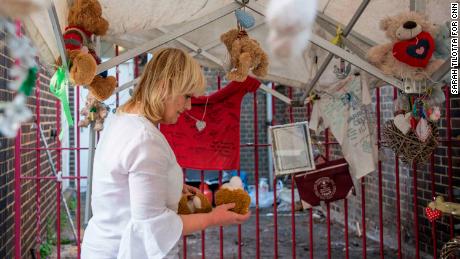 Bromley House resident Theresa Griffin holds a stuffed toy that has fallen apart at the memorial she tends in tribute to Grenfell victims.