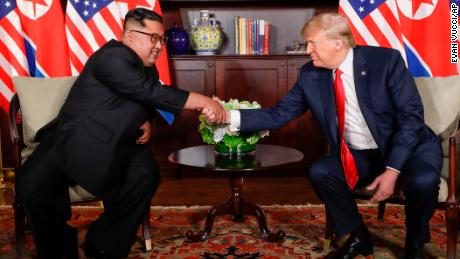 Trump shakes hands with North Korea leader Kim Jong Un during their first meetings at the Capella resort on Sentosa Island Tuesday, June 12, 2018 in Singapore. 