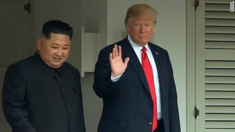 US President Donald Trump and North Korea&#39;s leader Kim Jong Un walk through the Capella Hotel after concluding the first series of talks.