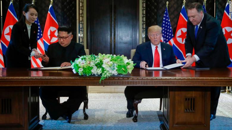 North Korea leader Kim Jong Un and US President Donald Trump sign a document in Singapore June 12.