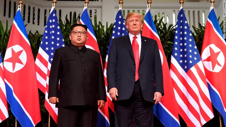 Trump poses with North Korea&#39;s leader Kim Jong Un at the start of their historic US-North Korea summit, at the Capella Hotel on Sentosa island in Singapore on June 12, 2018.