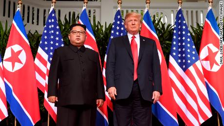 TOPSHOT - US President Donald Trump (R) poses with North Korea&#39;s leader Kim Jong Un (L) at the start of their historic US-North Korea summit, at the Capella Hotel on Sentosa island in Singapore on June 12, 2018. - Donald Trump and Kim Jong Un have become on June 12 the first sitting US and North Korean leaders to meet, shake hands and negotiate to end a decades-old nuclear stand-off. (Photo by SAUL LOEB / AFP)        (Photo credit should read SAUL LOEB/AFP/Getty Images)