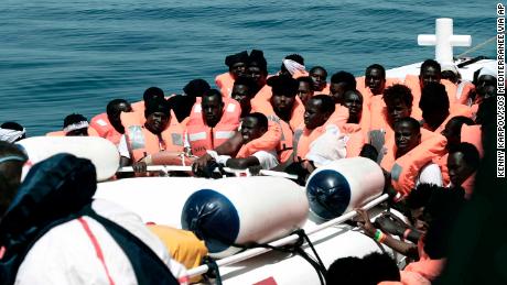 This undated photo released on Tuesday by SOS Méditerranée  shows stranded migrants from the Aquarius being transfered to an Italian Coast Guard boat before embarking on a journey to Spain. 