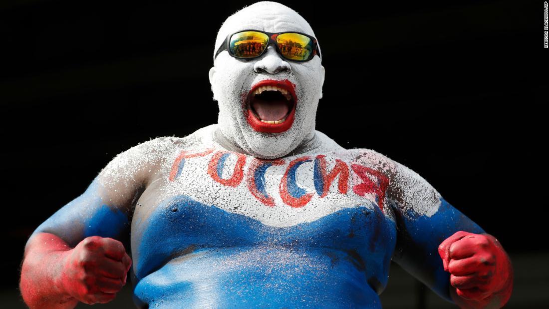 A fan wears body paint in Russia&#39;s colors before the opening match.