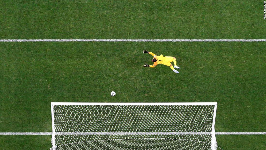The ball flies past Saudi Arabian goalkeeper Abdullah Al-Mayouf for Russia&#39;s fourth goal.