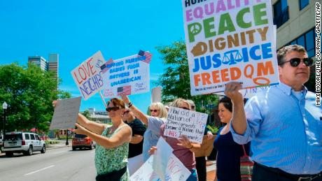 People line up outside Parkview Field with signs directed at US Attorney General Jeff Sessions. 