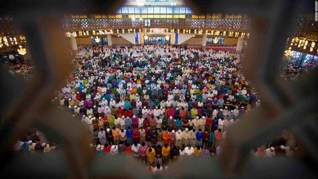 Muslims in Kuala Lumpur, Malaysia, offer prayers during the first day of Eid al-Fitr on Friday, June 15.