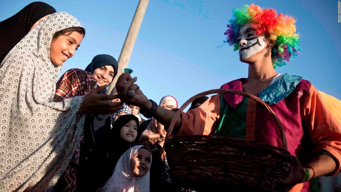 A clown gives out candy in Gaza City.