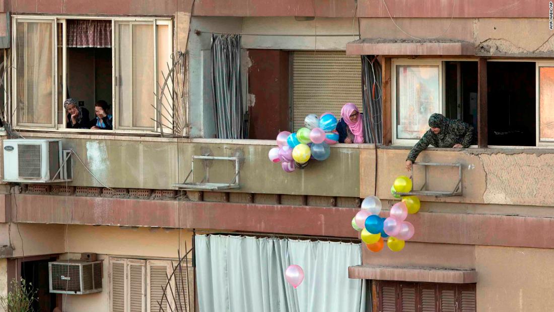 People throw balloons to passers-by in Cairo.