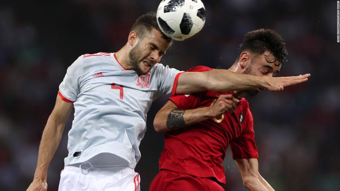 Spanish defender Nacho, left, competes for a header with Portugal&#39;s Bruno Fernandes. Nacho conceded the early penalty to Ronaldo but responded with a second-half goal.