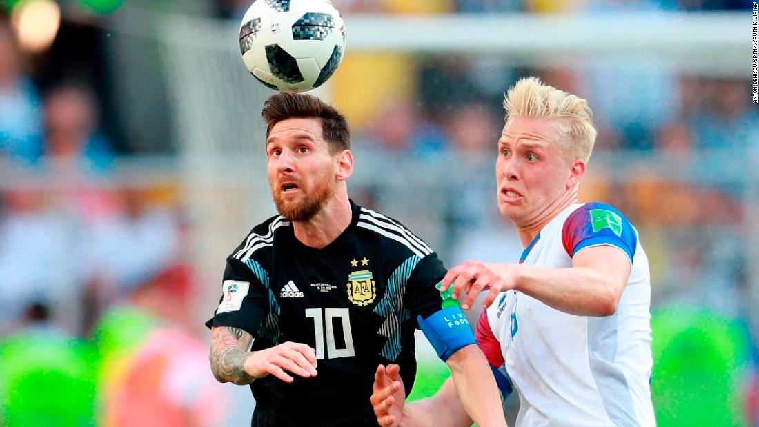 Messi and Iceland&#39;s Hordur Magnusson struggle for the ball.