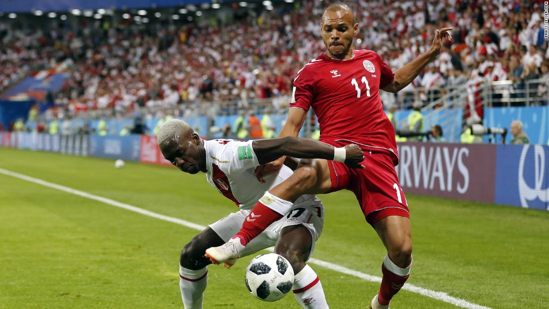 Peru&#39;s Luis Advincula, left, and Denmark&#39;s Martin Braithwaite fight for the ball.