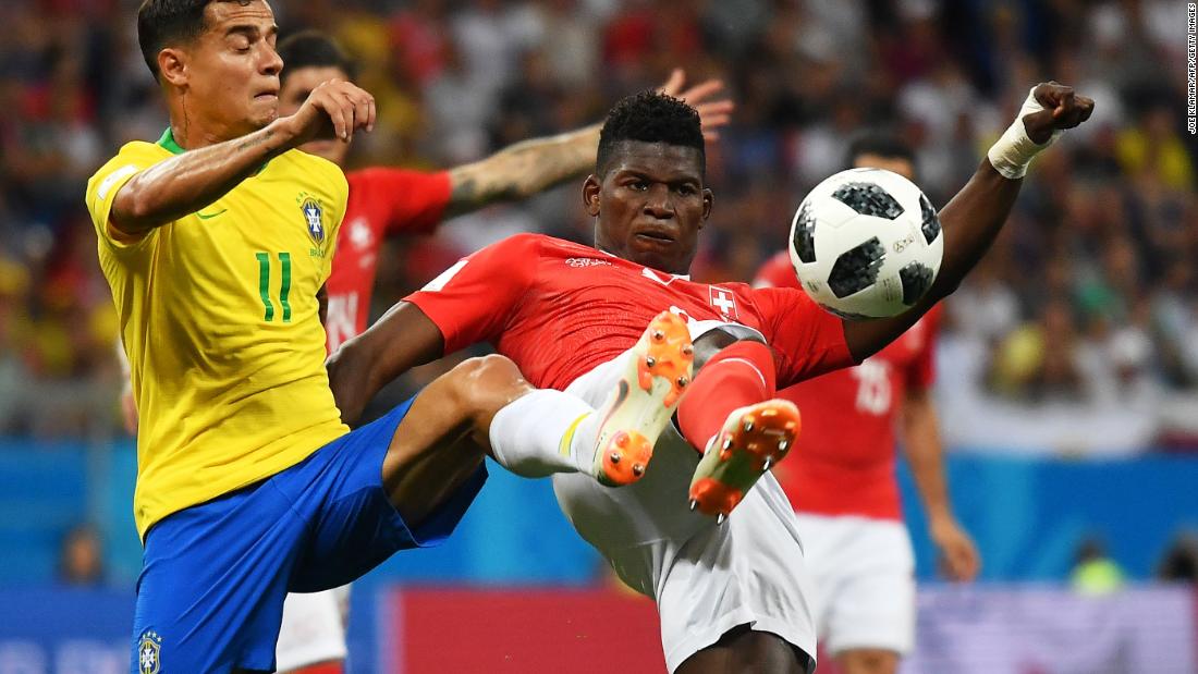 Brazil&#39;s Philippe Coutinho and Switzerland&#39;s Breel Embolo compete for the ball.