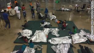 Inside Border Protection's processing detention center: Chain link fences and thermal blankets