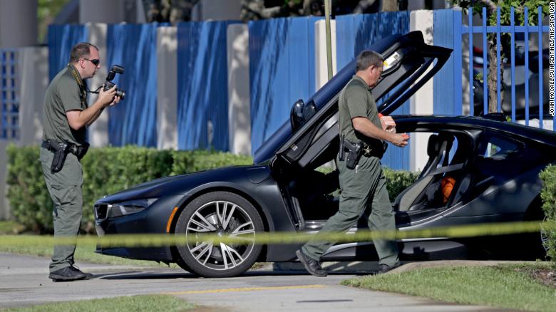 A BMW sits idle after reports of a shooting in Deerfield Beach involving rapper XXXTentacion on Monday.