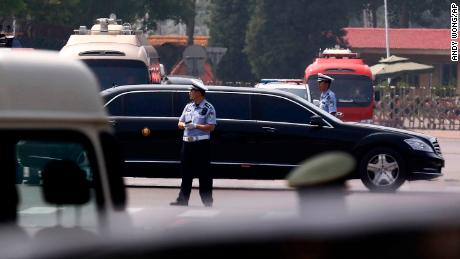 The motorcade in which Kim is believed to be traveling passes by policemen as it leaves the Beijing Capital International Airport.