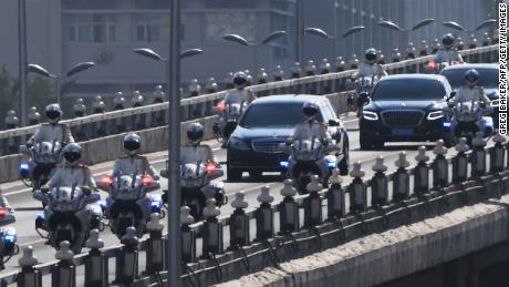 The car believed to be carrying North Korean leader Kim Jong Un is escorted by motorcycles in Beijing on Tuesday.